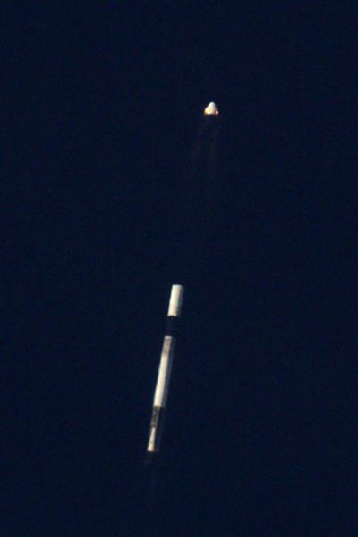 SpaceX's Crew Dragon capsule flies away from its Falcon 9 rocket, whose nine Merlin engines are now shut down, during the In-Flight Abort test on January 19, 2020.