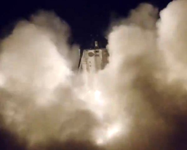 A video screenshot of SpaceX's Starship vehicle prototype, called Starhopper, enshrouded in a cloud of smoke as it lifts off from the company's Boca Chica launch site on July 25, 2019.