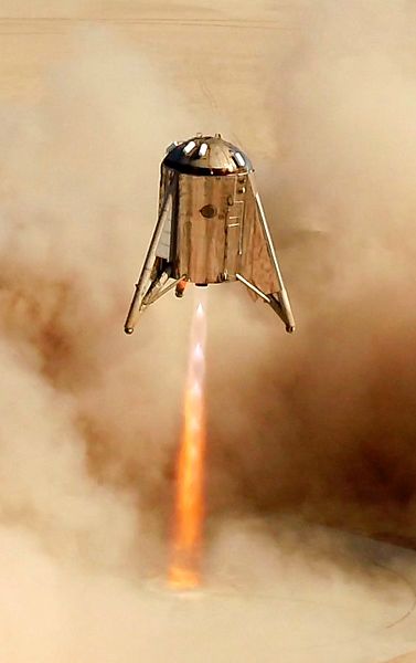 SpaceX's Starhopper prototype vehicle prepares to touch down at its landing site after conducting a test flight that lasted 57 seconds above Boca Chica, Texas...on August 27, 2019.