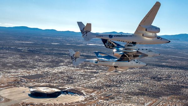 The VSS Unity, attached to her mothership VMS Eve, flies over New Mexico's Spaceport America...their new home.