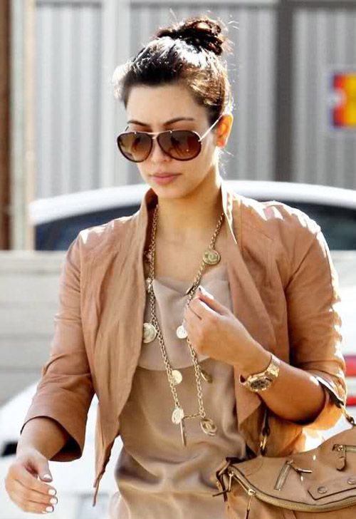 Kim Kardashian sporting a gold AP RO